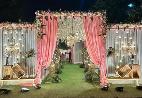 budget-friendly wedding entrance ideas 2026 floral arch drapes lights